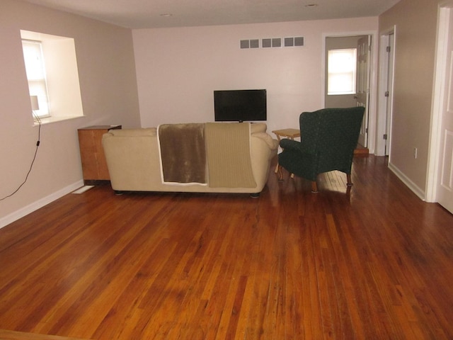 unfurnished living room with plenty of natural light and dark wood-type flooring