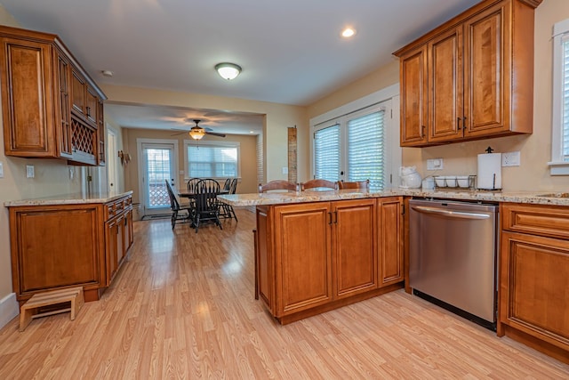 kitchen featuring dishwasher, kitchen peninsula, light hardwood / wood-style flooring, and a wealth of natural light