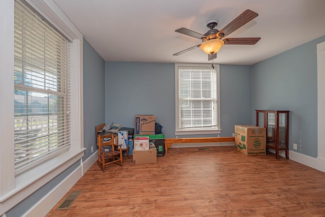 rec room with ceiling fan, light hardwood / wood-style floors, and a wealth of natural light