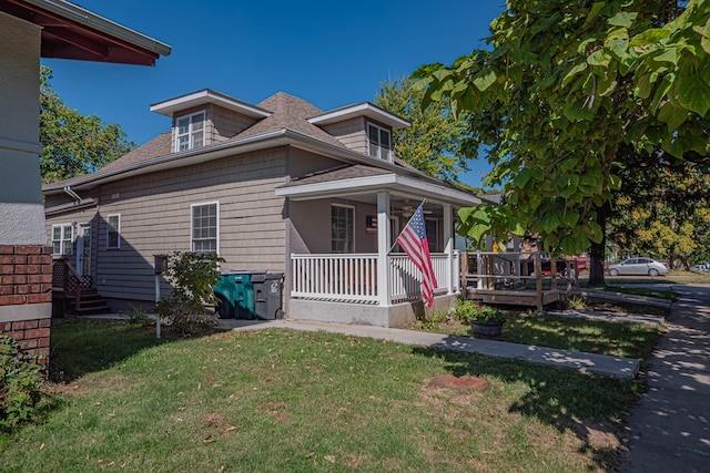 bungalow with a front lawn and a porch