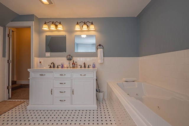 bathroom featuring tile patterned flooring, vanity, and a relaxing tiled tub