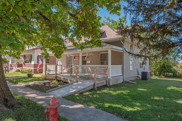 view of front facade featuring central AC unit, ceiling fan, a porch, and a front lawn