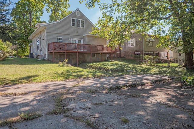 back of house featuring a yard, a deck, and central air condition unit