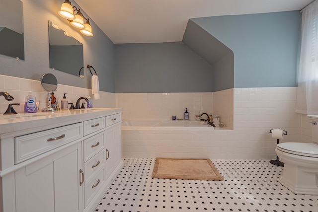 bathroom featuring vanity, tile patterned flooring, toilet, tile walls, and tiled bath