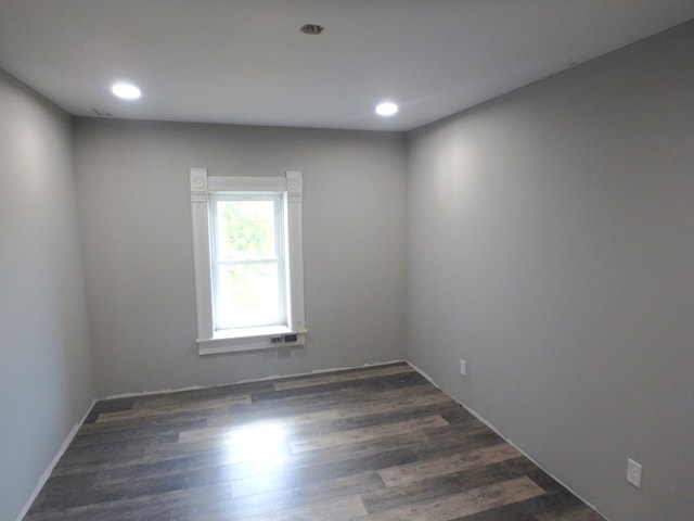 empty room with dark hardwood / wood-style flooring