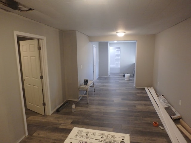 corridor with dark wood-type flooring