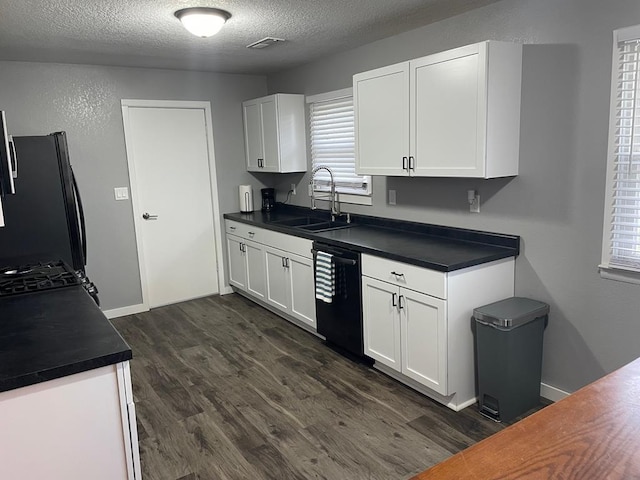 kitchen featuring sink, white cabinetry, dark wood-type flooring, and black appliances