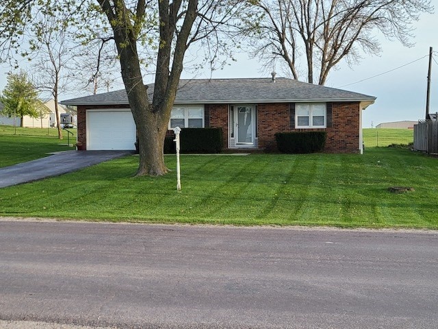 single story home featuring a front yard and a garage