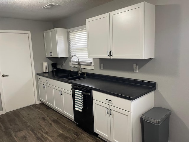 kitchen featuring white cabinetry, dishwasher, sink, dark hardwood / wood-style flooring, and a textured ceiling