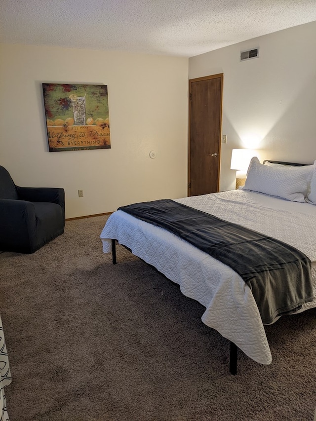 2602 Woodwinds Ct, Kirksville, MO 63501 - bedroom with visible vents, a textured ceiling, and carpet flooring