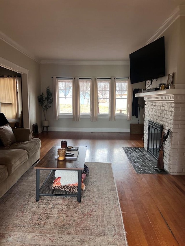 living room with wood-type flooring, a brick fireplace, and ornamental molding