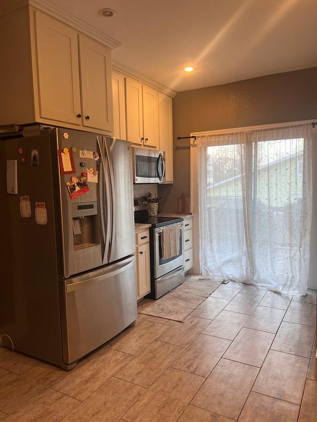 kitchen with white cabinets and appliances with stainless steel finishes