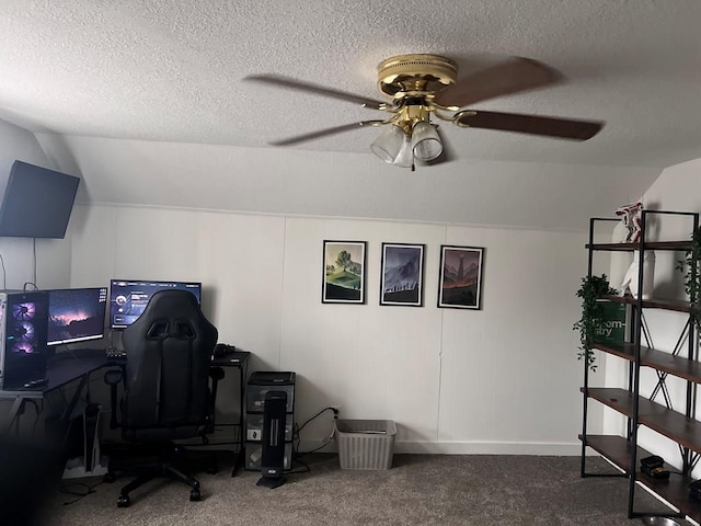 carpeted home office featuring a textured ceiling, ceiling fan, and lofted ceiling