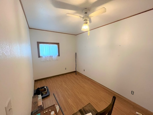 spare room featuring hardwood / wood-style flooring, ceiling fan, and ornamental molding