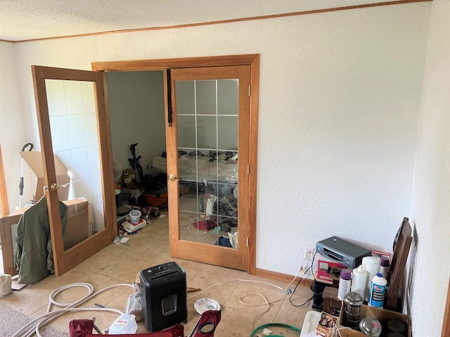 misc room featuring light tile patterned floors, crown molding, and french doors