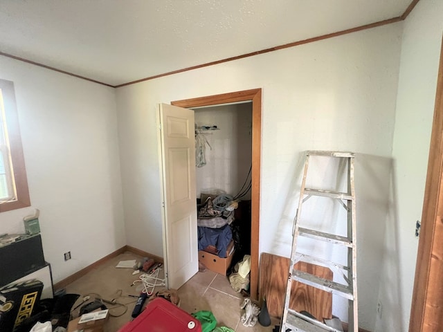 interior space featuring ornamental molding and light tile patterned flooring