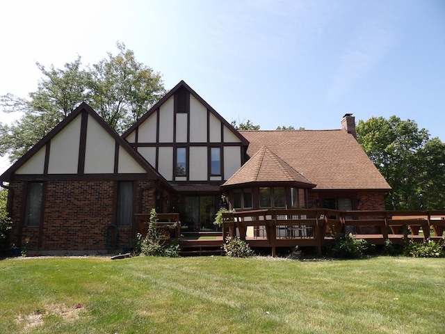 rear view of property featuring a yard and a deck