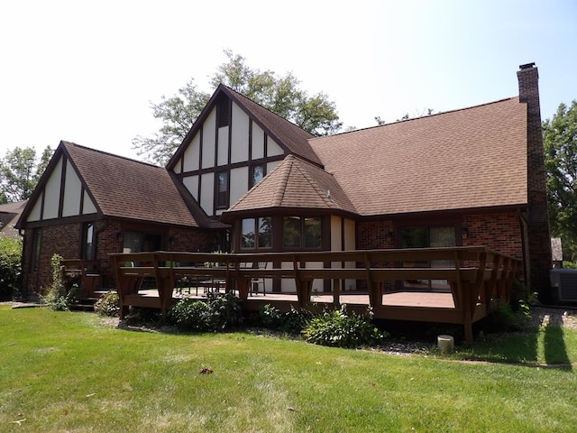 back of house with a wooden deck, a yard, and cooling unit