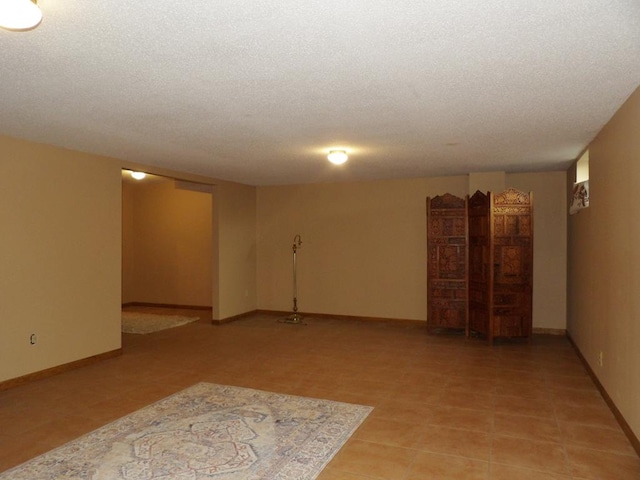 unfurnished room with a textured ceiling