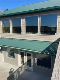 view of side of home with a patio area