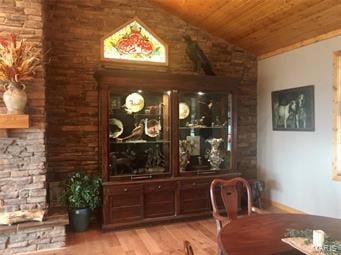 dining area with light hardwood / wood-style flooring, vaulted ceiling, and wood ceiling