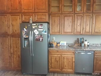 kitchen with hardwood / wood-style flooring, light stone countertops, and stainless steel appliances