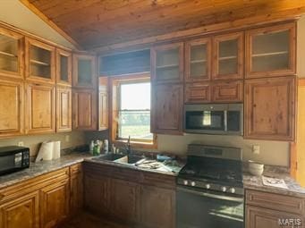 kitchen with sink, wood ceiling, stainless steel appliances, and vaulted ceiling