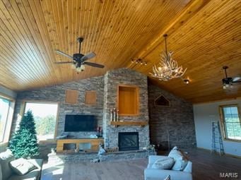 unfurnished living room featuring ceiling fan, a fireplace, a healthy amount of sunlight, and lofted ceiling