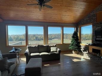 living room with ceiling fan, plenty of natural light, wood ceiling, and lofted ceiling