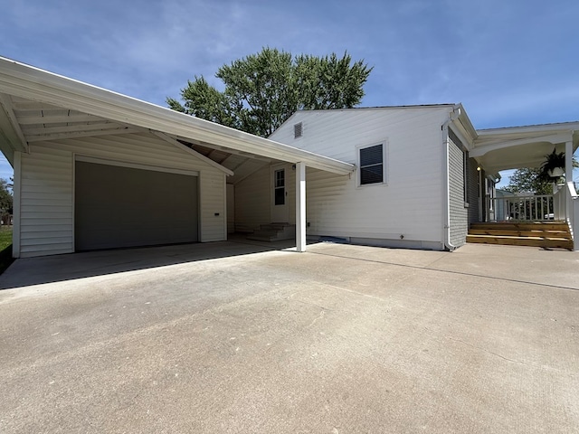 713 E Dear St, Kirksville, MO 63501 - view of front of house with driveway, a carport, and an attached garage