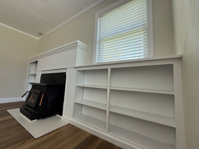 713 E Dear St, Kirksville, MO 63501 - detailed view of a wood stove, ornamental molding, wood finished floors, and baseboards