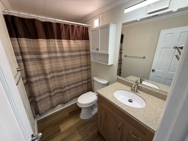 713 E Dear St, Kirksville, MO 63501 - full bathroom with wood finished floors, toilet, ornamental molding, vanity, and a textured ceiling