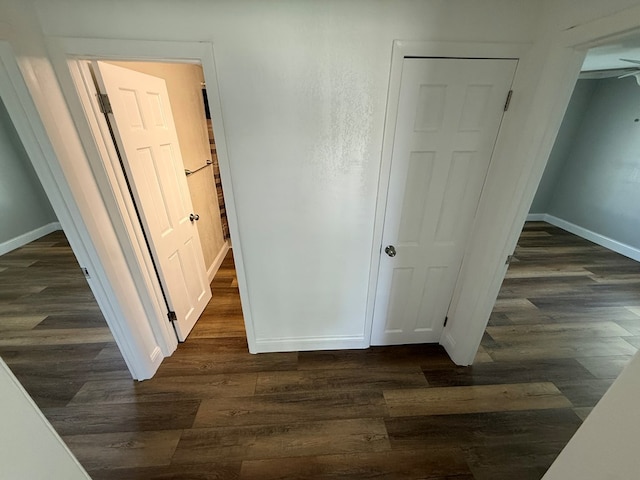 713 E Dear St, Kirksville, MO 63501 - unfurnished bedroom with baseboards and dark wood-style floors