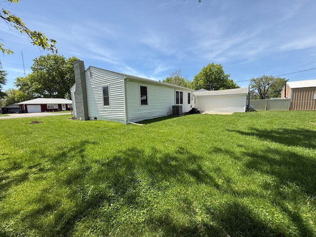 713 E Dear St, Kirksville, MO 63501 - rear view of house featuring a chimney, central air condition unit, and a garage
