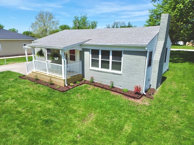 713 E Dear St, Kirksville, MO 63501 - ranch-style home featuring covered porch, a chimney, brick siding, a shingled roof, and a front lawn