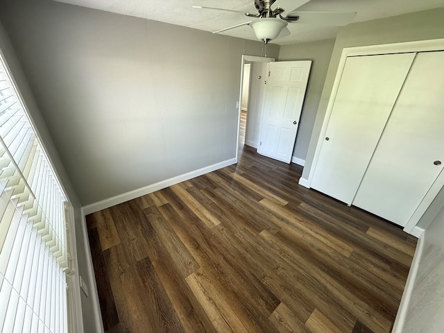 713 E Dear St, Kirksville, MO 63501 - unfurnished bedroom with baseboards, dark wood-style floors, and multiple windows