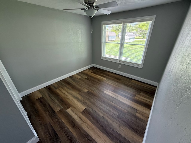 713 E Dear St, Kirksville, MO 63501 - spare room with baseboards, dark wood-type flooring, and ceiling fan