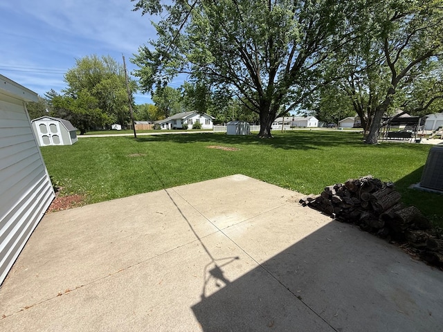 713 E Dear St, Kirksville, MO 63501 - view of patio featuring a storage unit, central air condition unit, and an outdoor structure