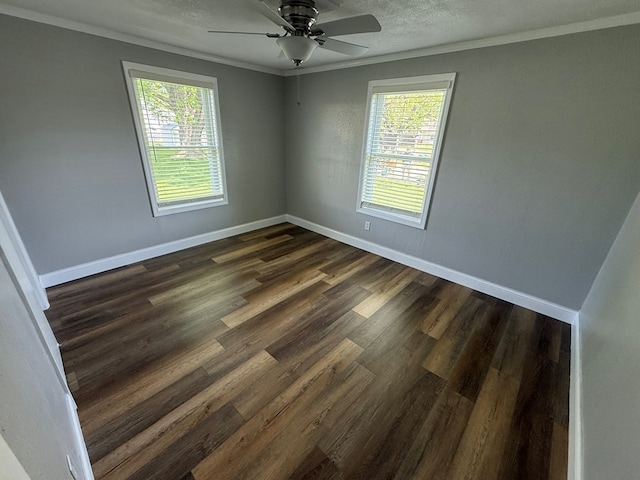 713 E Dear St, Kirksville, MO 63501 - spare room featuring crown molding, plenty of natural light, baseboards, and dark wood-style flooring