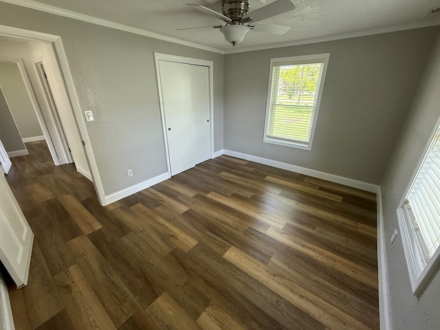 713 E Dear St, Kirksville, MO 63501 - unfurnished bedroom with ornamental molding, baseboards, dark wood-style floors, and a ceiling fan