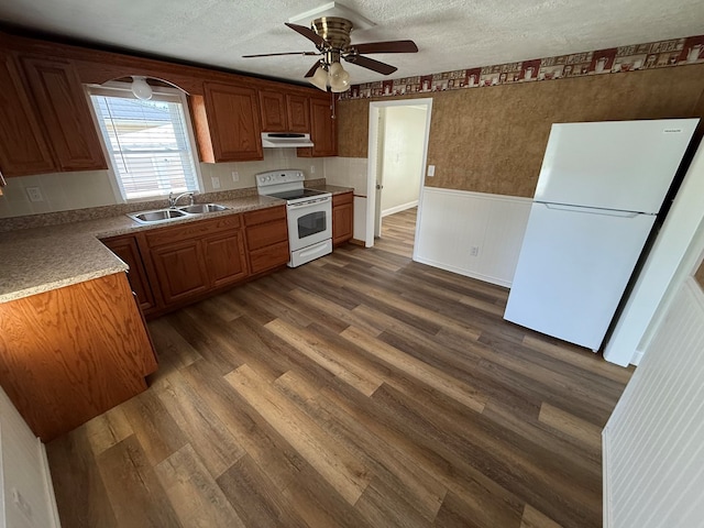 713 E Dear St, Kirksville, MO 63501 - kitchen featuring white appliances, a sink, dark wood-type flooring, under cabinet range hood, and ceiling fan