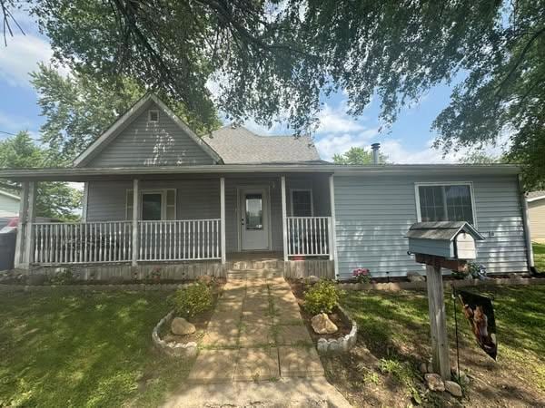 228 S Vine St, Milan, MO 63556 - view of front of house featuring covered porch and a front yard