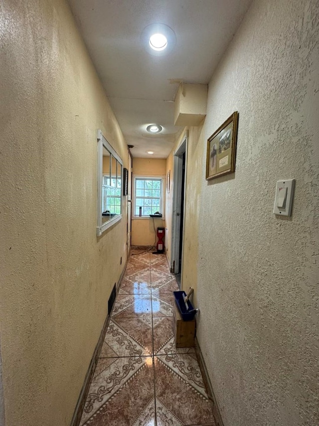 228 S Vine St, Milan, MO 63556 - hall with a textured wall, inlaid floor details, and recessed lighting