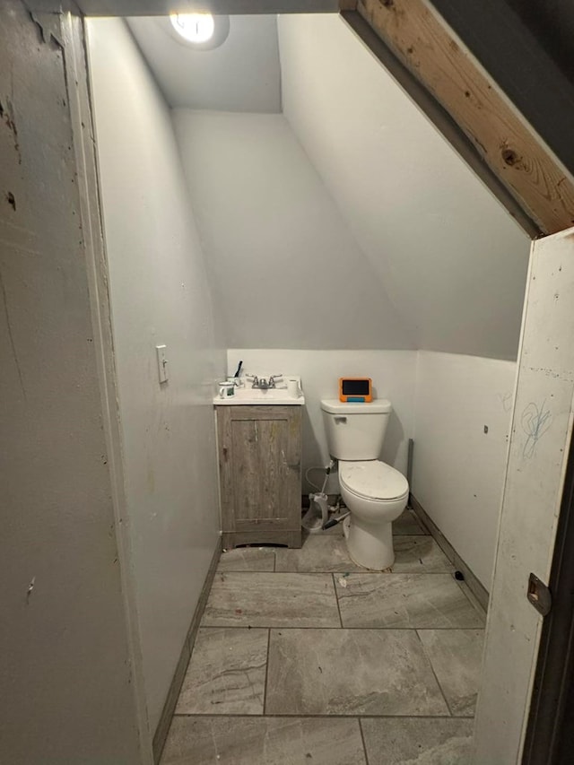 228 S Vine St, Milan, MO 63556 - half bathroom featuring vanity and vaulted ceiling