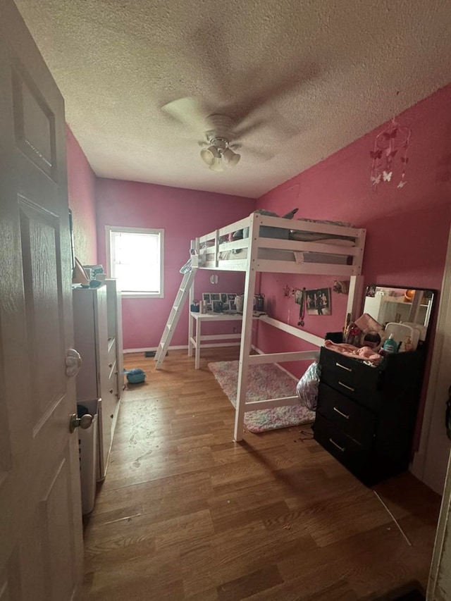 228 S Vine St, Milan, MO 63556 - bedroom with wood finished floors, a textured ceiling, and ceiling fan