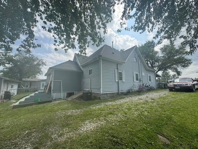 228 S Vine St, Milan, MO 63556 - view of home's exterior featuring a yard and roof with shingles