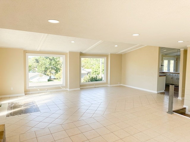 spare room with light tile patterned flooring and ornamental molding