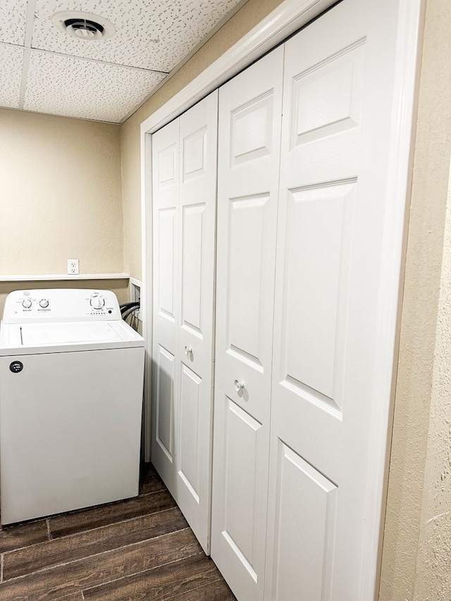 clothes washing area featuring washer / dryer and dark wood-type flooring