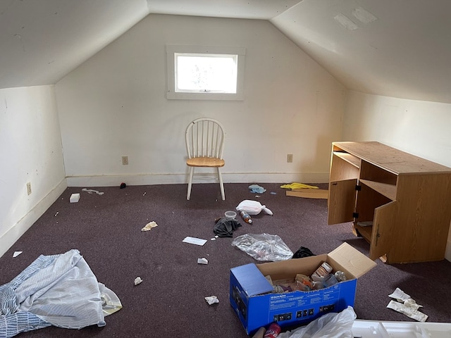 bonus room with lofted ceiling and baseboards