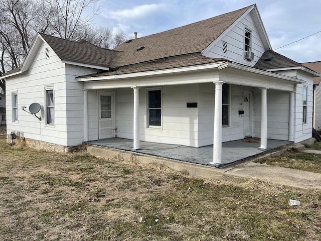 view of front of property with a shingled roof and a porch